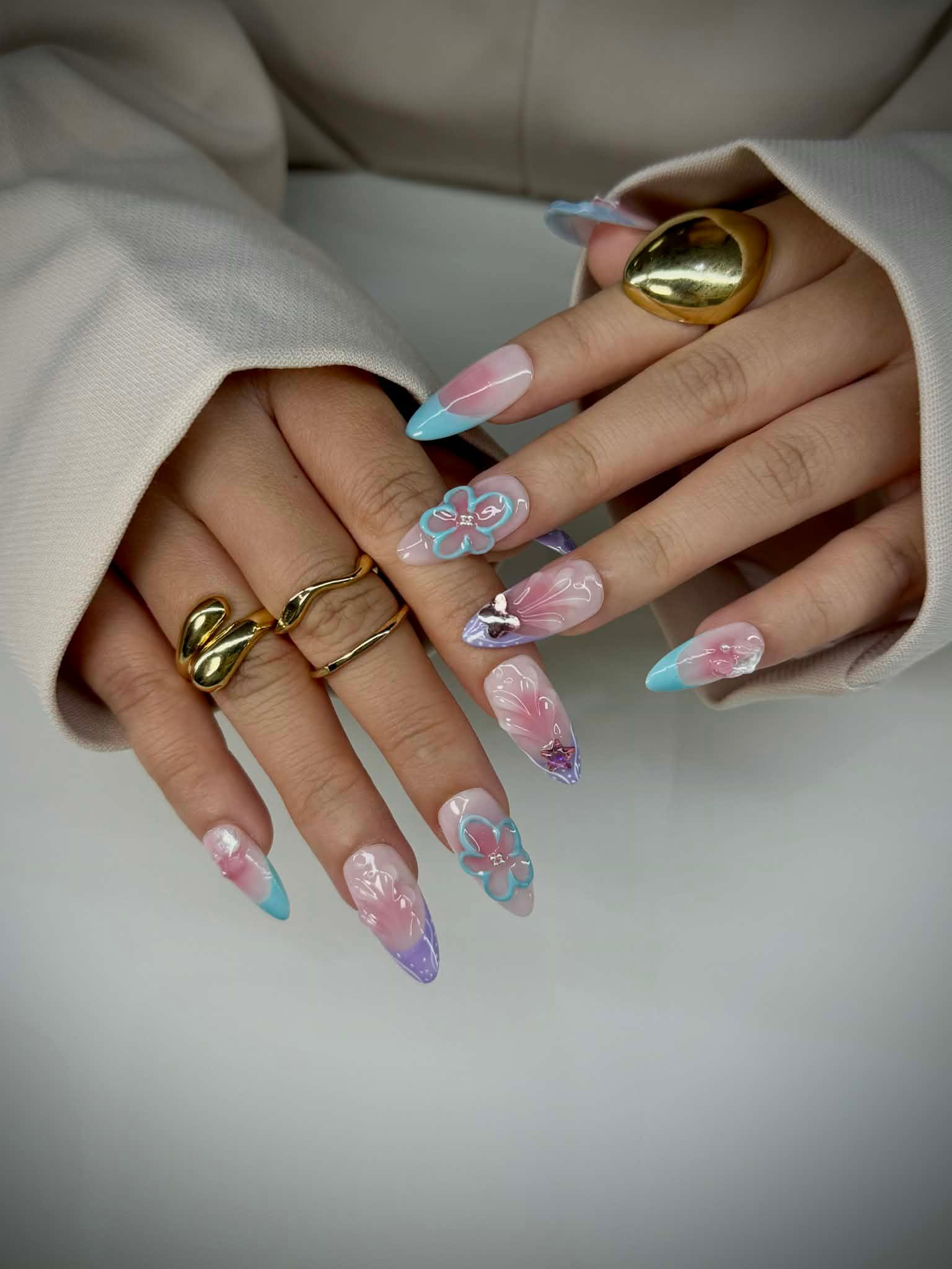 Long almond acrylic nails with pastel blue and pink floral nail art design1621243260e1af0c20-0